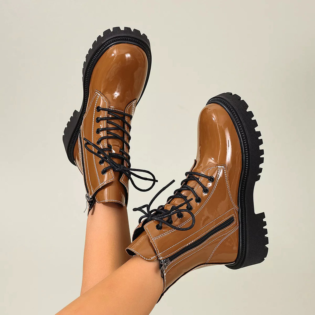 Tan lace-up block heel boots with black trim and thick lug sole