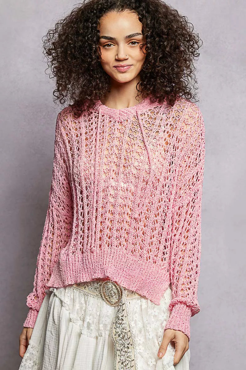 Pink openwork knit top with round neck, long sleeves, and high-low hem