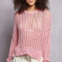 Pink openwork knit top with round neck, long sleeves, and high-low hem