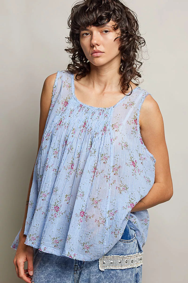 Blue floral pleated cotton sleeveless top with round neckline, draped pleats