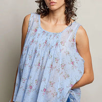 Blue floral pleated cotton sleeveless top with round neckline, draped pleats