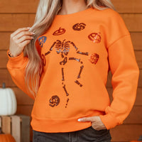 Orange Halloween crewneck sweatshirt with sequin critter icons and skeleton graphic