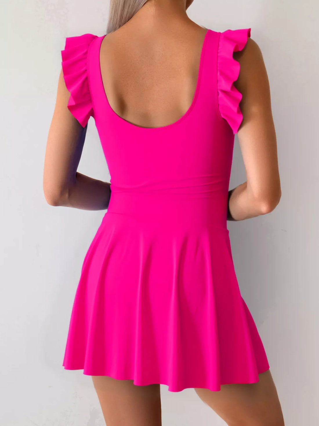 Hot pink ruffled-sleeve swim dress with scooped back and gathered skirt hem
