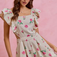 Ivory floral romper with ruffled cap sleeves and gathered waist, pink rose print