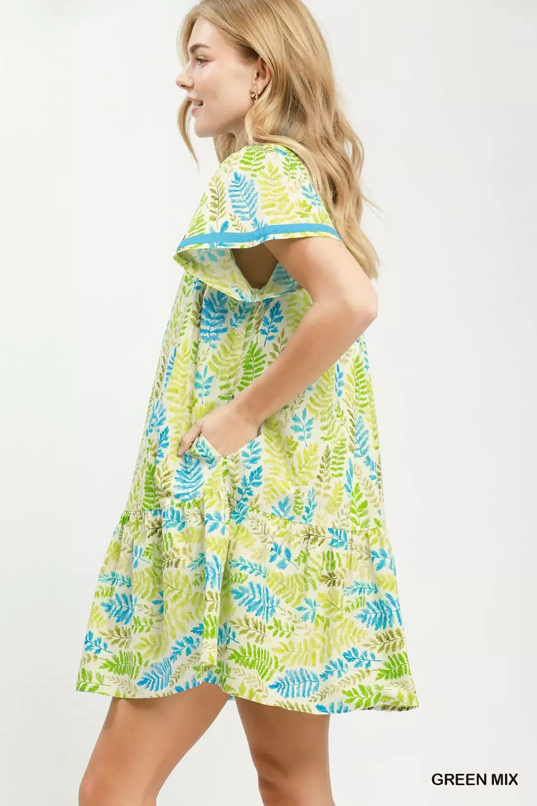 Green and blue leaf print tiered mini dress with flutter sleeves, side view