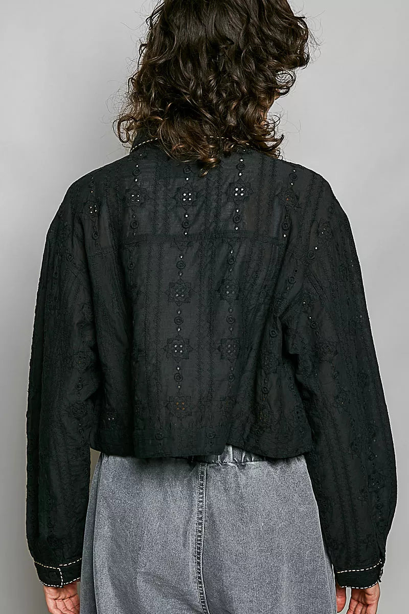 Black cropped eyelet cotton jacket, back view with row of small button details and yoke.