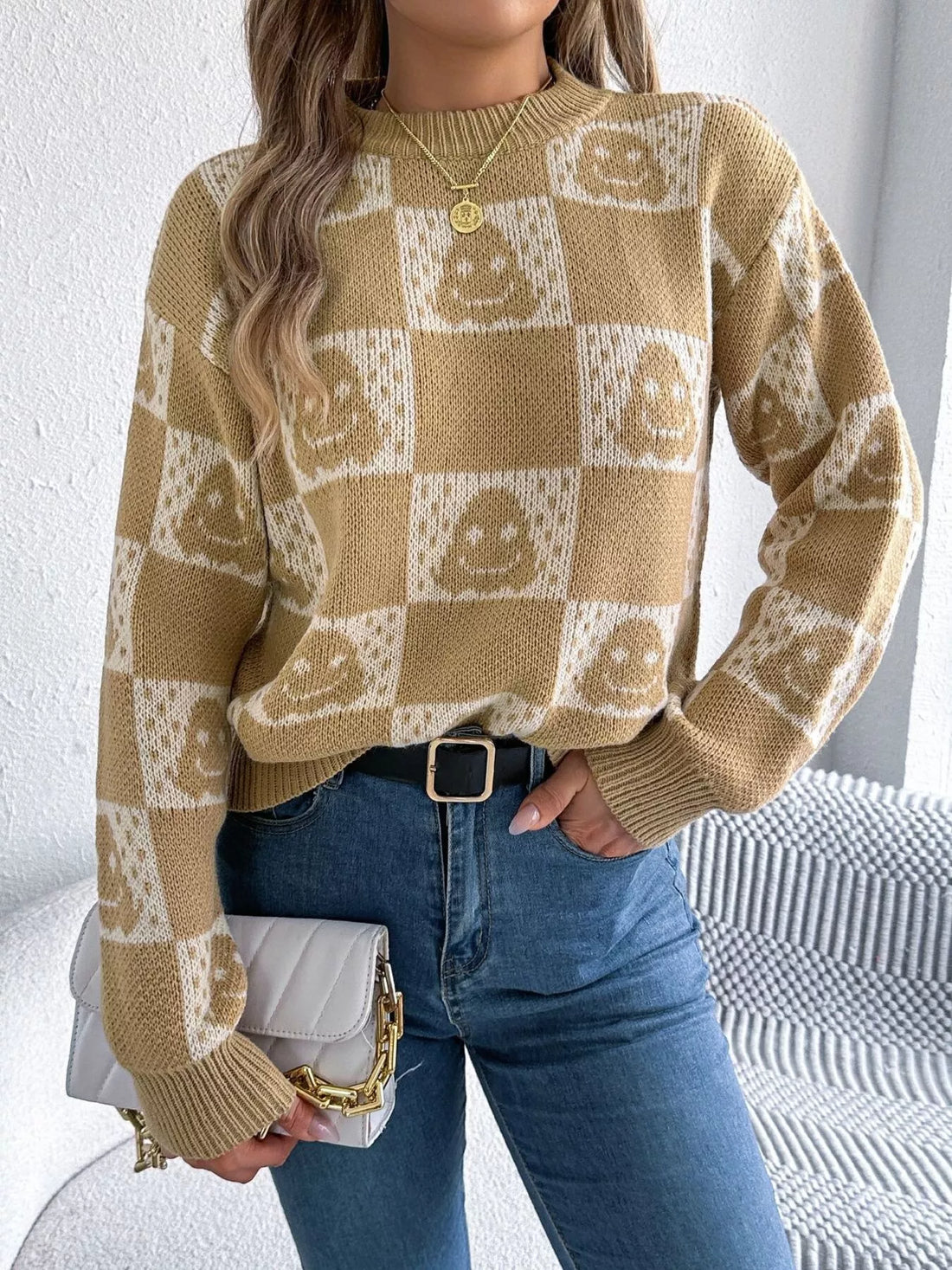 Beige checkerboard knit sweater with jack-o-lantern face print, crew neck, long sleeves