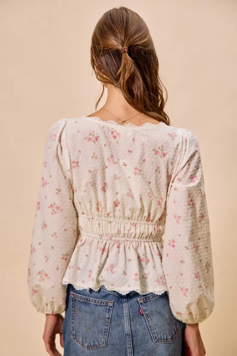 White floral clip-dot blouse back view with gathered elastic waist and full puff sleeves