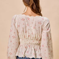 White floral clip-dot blouse back view with gathered elastic waist and full puff sleeves