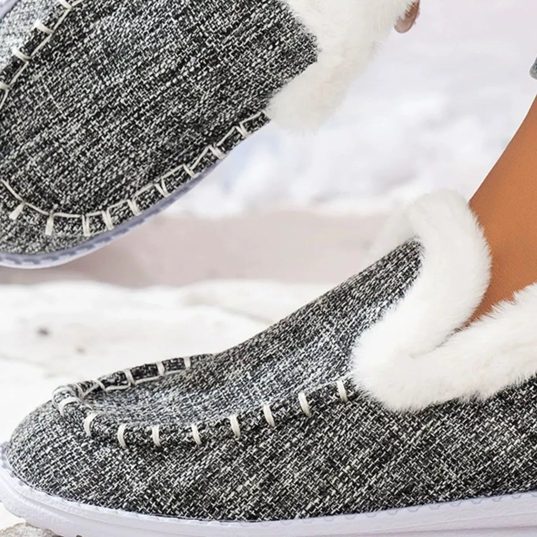 Grey faux fur lined round toe slip-on shoes, close-up of front and stitched trim