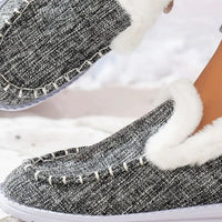 Grey faux fur lined round toe slip-on shoes, close-up of front and stitched trim