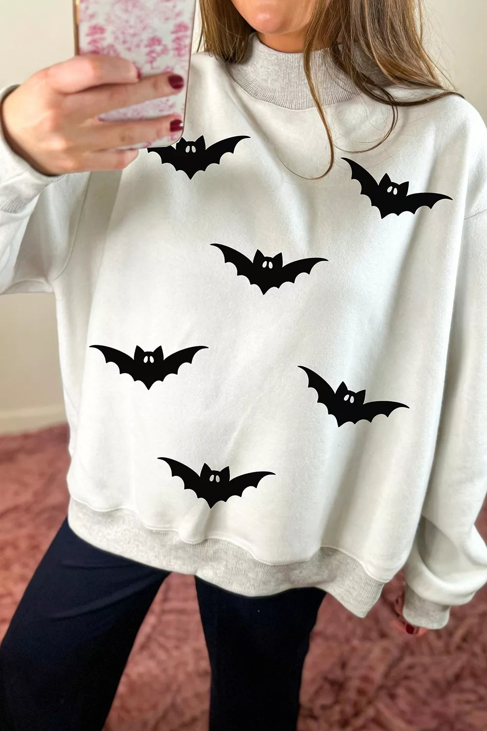 Light gray reversible mock-neck sweatshirt with scattered black bat print and red mock collar