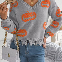 Gray pumpkin knit sweater with orange jack-o’-lantern motifs and ragged distressed hem