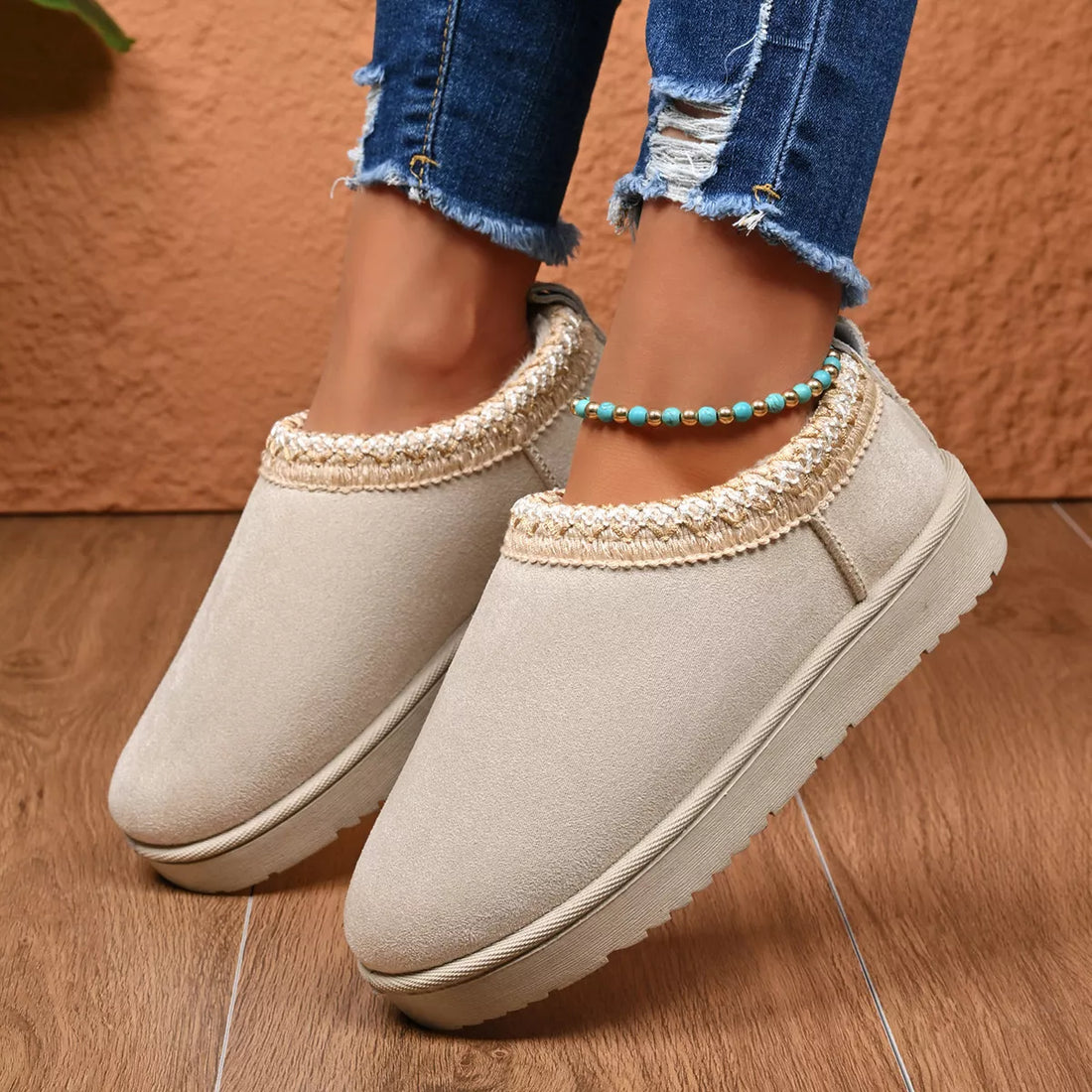 Light beige platform ankle boots with textured trim and beaded ankle bracelet