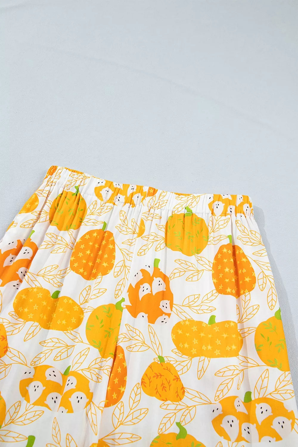 Printed lounge shorts with orange pumpkin and leaf pattern, elastic waistband