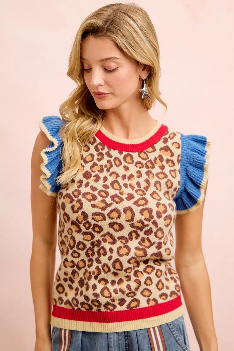 Leopard print knit top with blue ruffled sleeves and red-striped ribbed hem