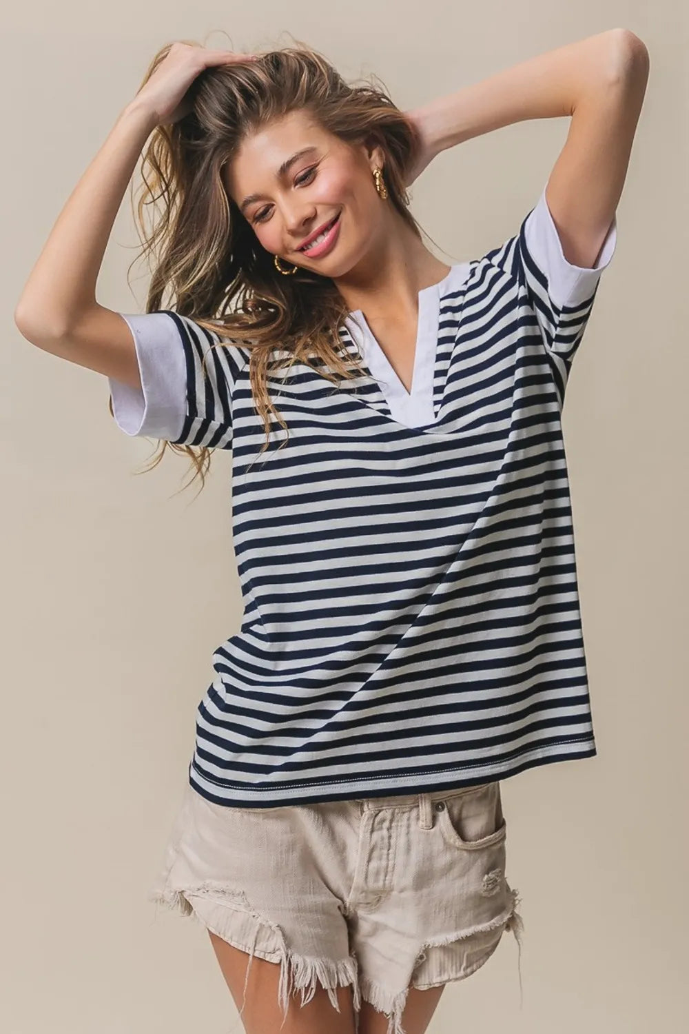 Contrast striped notched knit top, navy and ivory with V-neck and short sleeves.