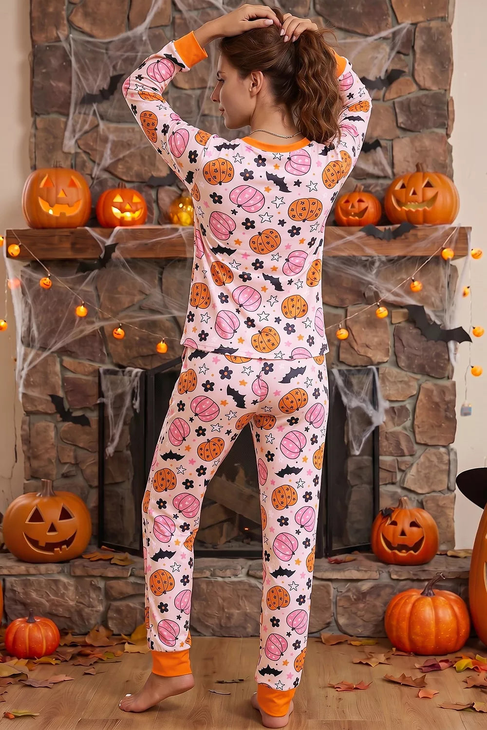 Dusty pink pumpkin-print long-sleeve pajama set with orange trim and matching jogger pants