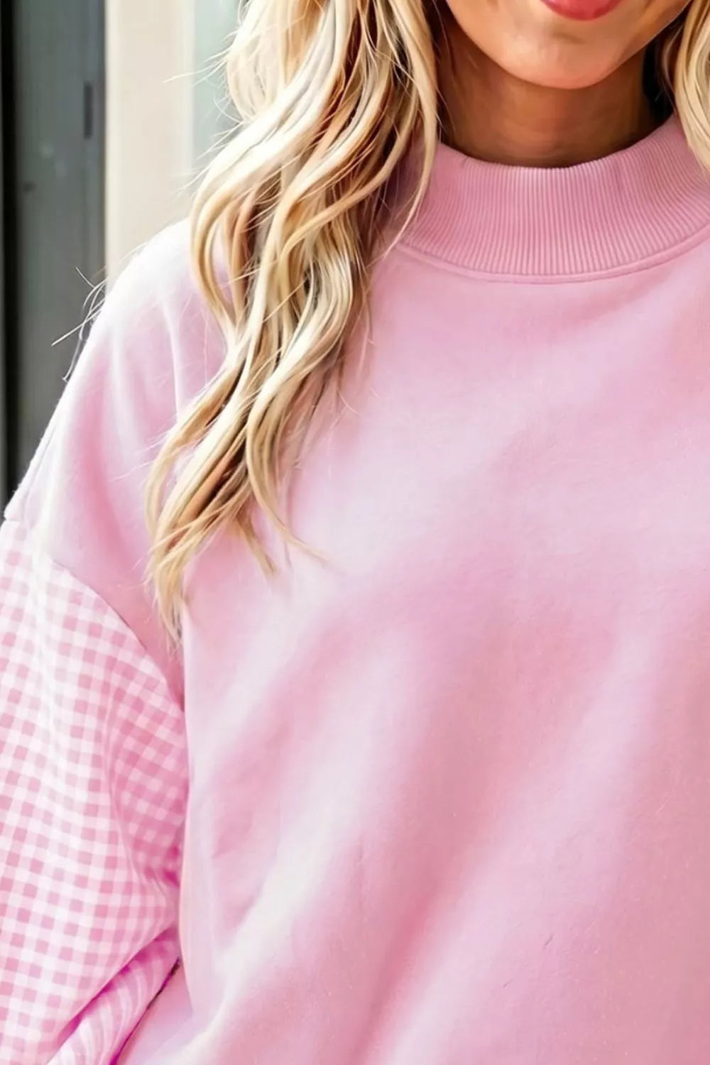 Blush pink loose tunic sweatshirt with ribbed crew neck and plaid sleeve