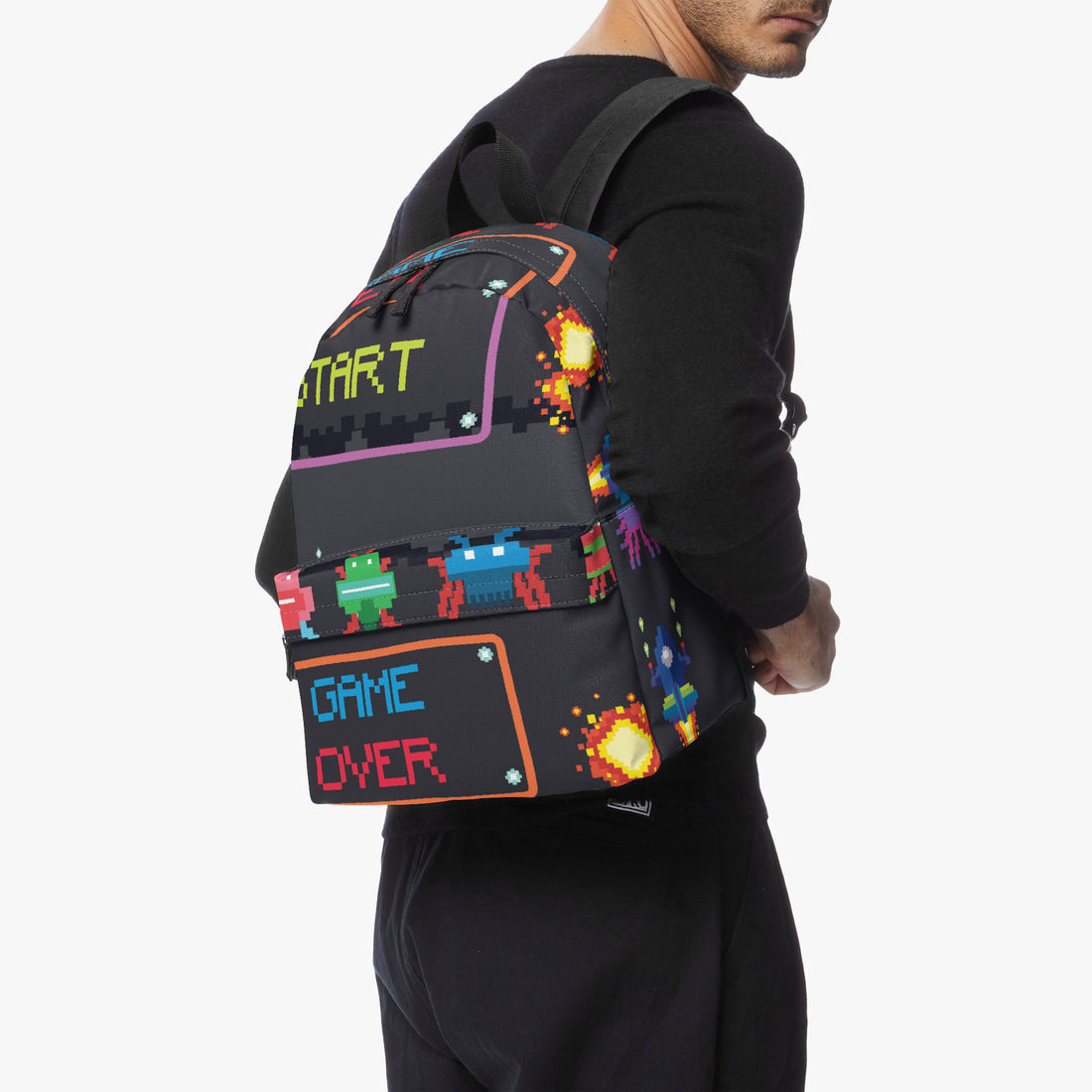 Kids canvas backpack on wearer, black with pixel “START” and “GAME OVER” graphic.