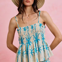 Blue palm-print smocked cami top with adjustable straps and ruffled peplum hem