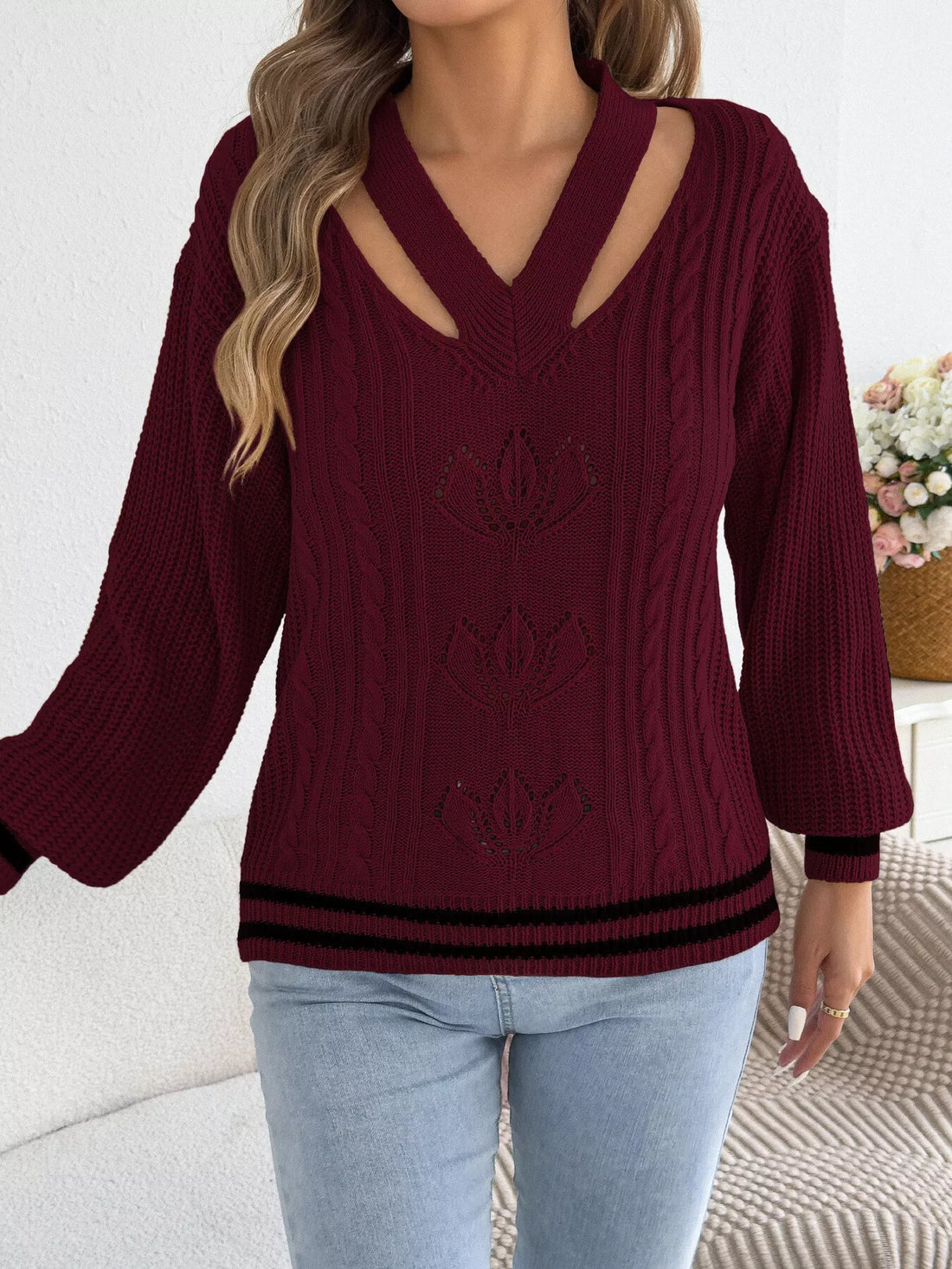 Burgundy cable knit sweater with V-neck cutouts at shoulders and ribbed bottom