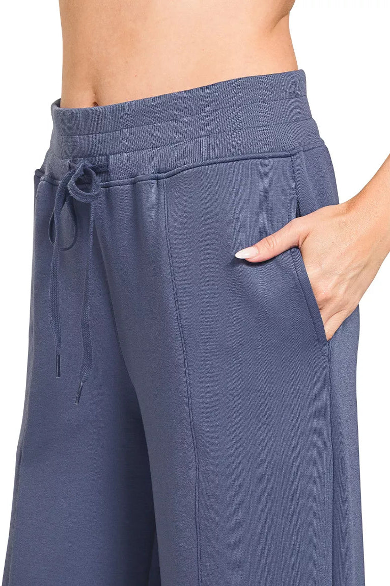 Blue indigo wide-leg pants with drawstring waist and center seams
