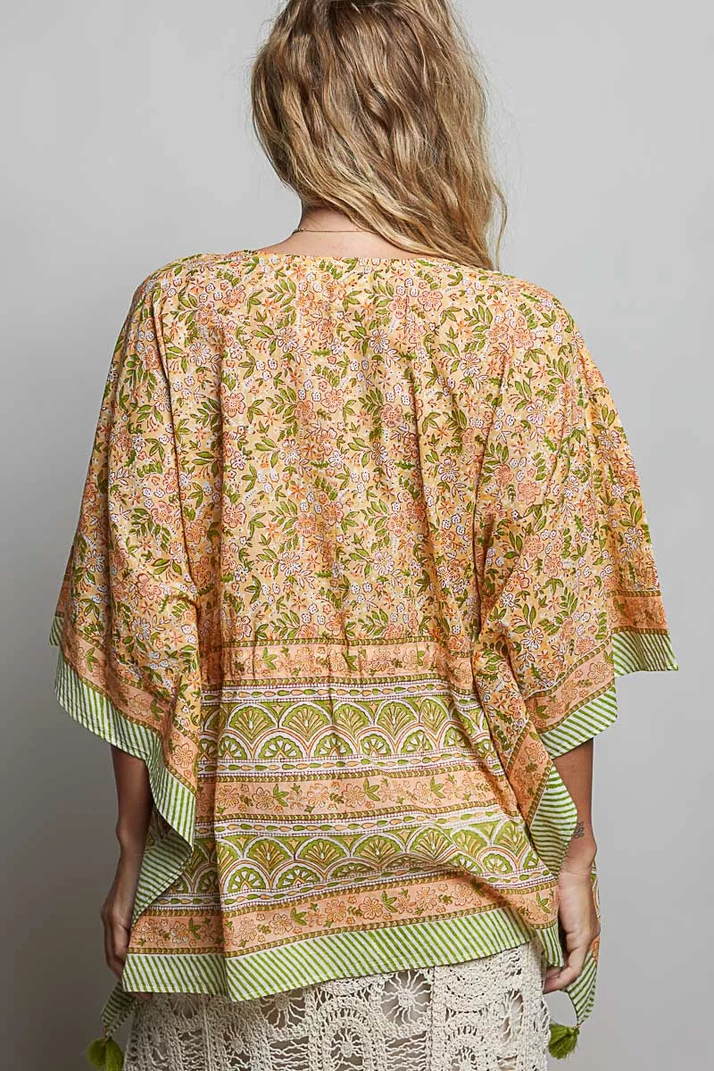 Back of coral floral tie-front blouse with V-neck and striped banded hem