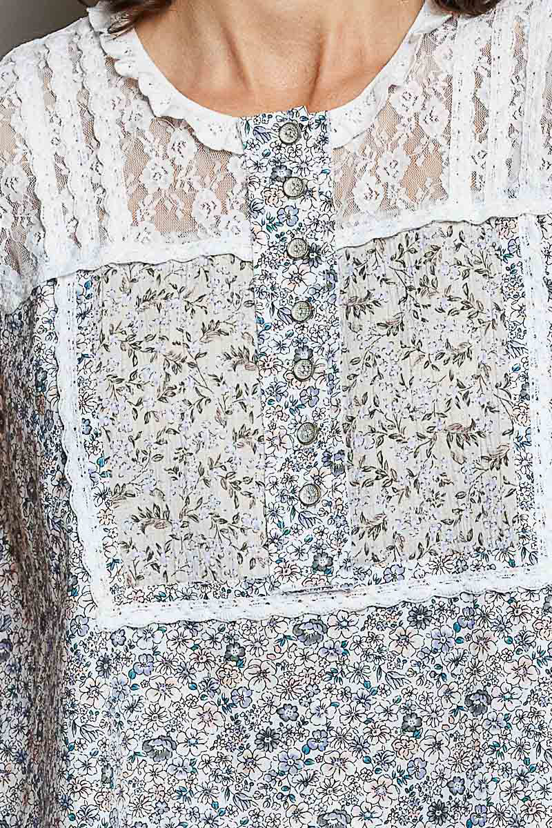 Off-white sleeveless woven lace top with button placket and blue floral print