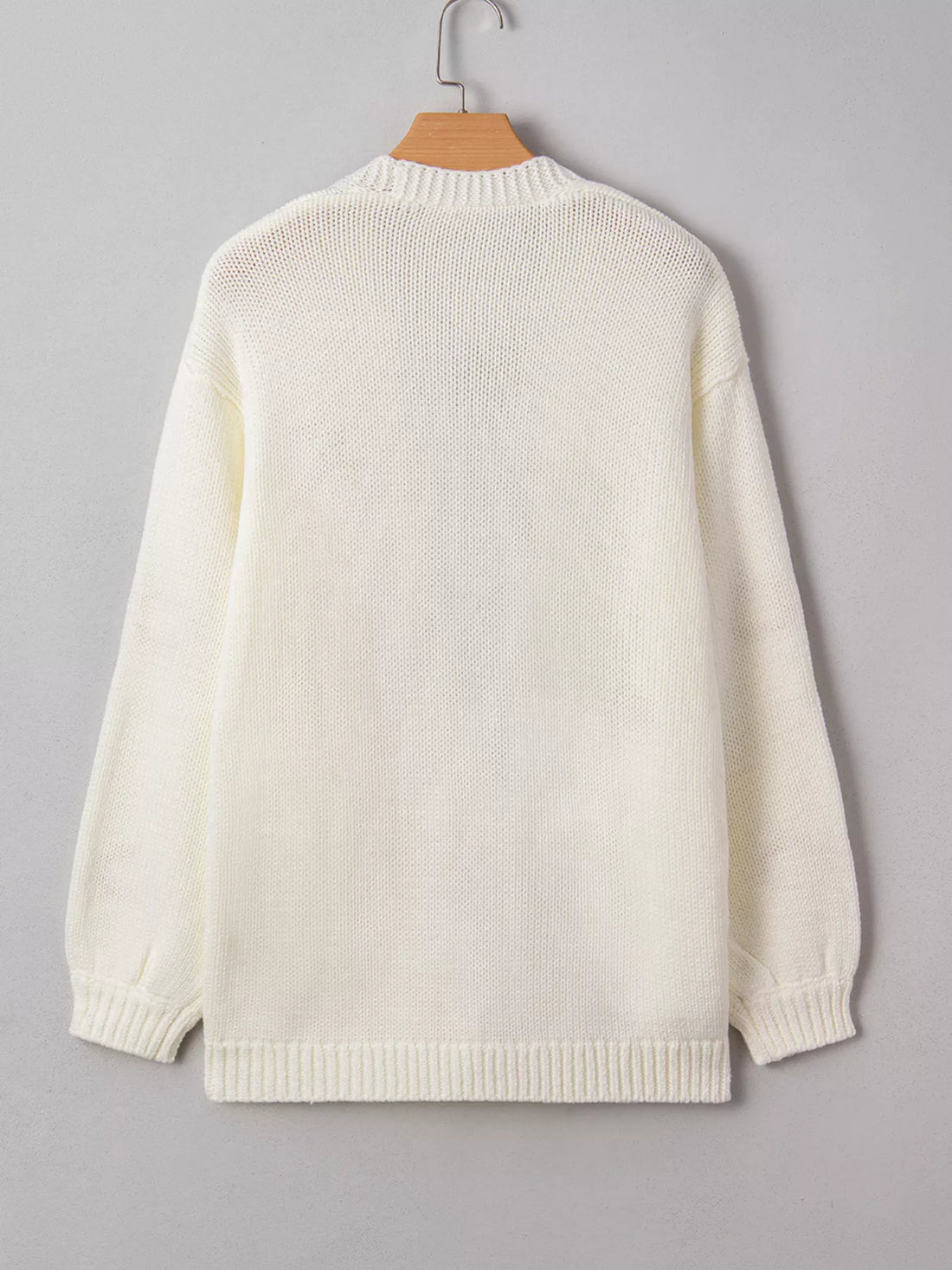 Off-white knit cardigan sweater back view with ribbed hem and long sleeves.