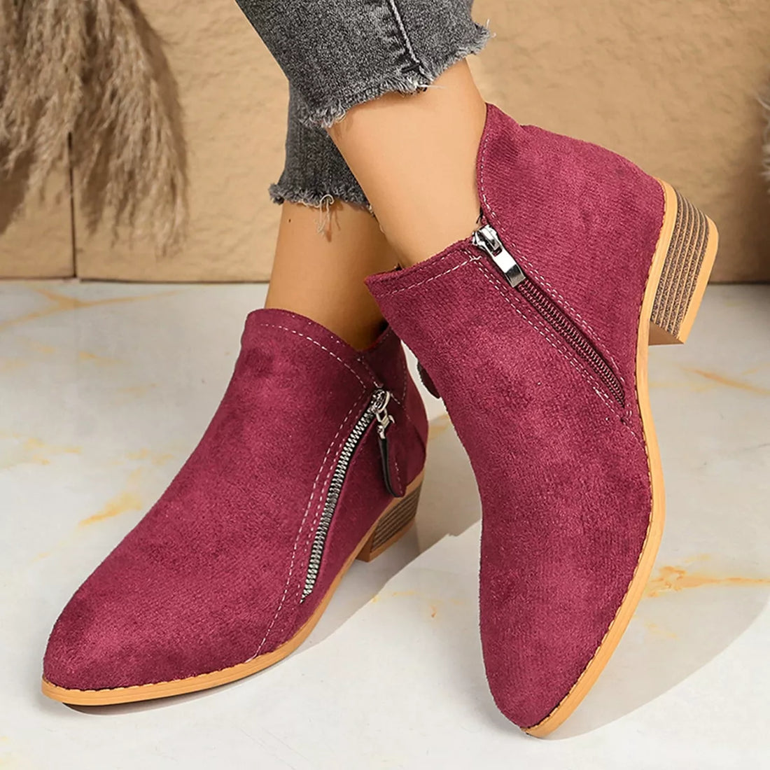 Burgundy point-toe block heeled ankle boots with side zipper and tan outsole