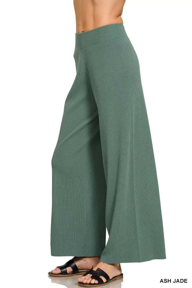 Teal-green wide-leg pants with draped knit texture and elastic waist