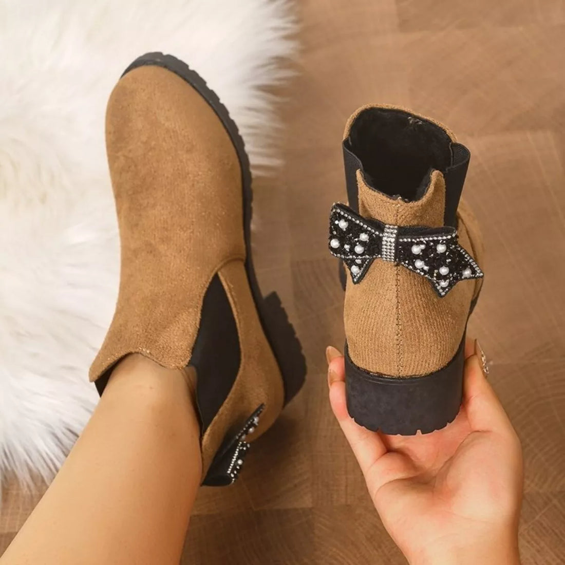 Tan suede ankle boots with round toe, block heel, jeweled bow, and plush lining