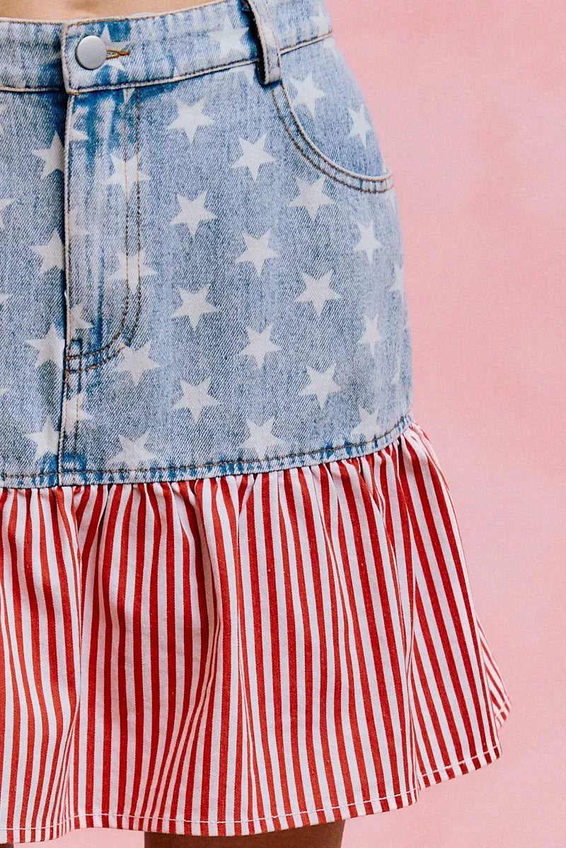 Blue denim skirt with star print, button waistband, and red-and-white striped ruffle tier.