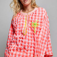Pink gingham embroidered blouse with vertical trim and palm tree motif
