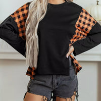 Black long-sleeve top with orange and black plaid side panels