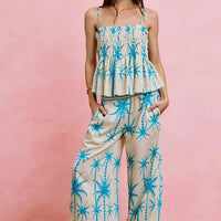 Blue palm-print smocked cami top with adjustable straps and tiered peplum hem