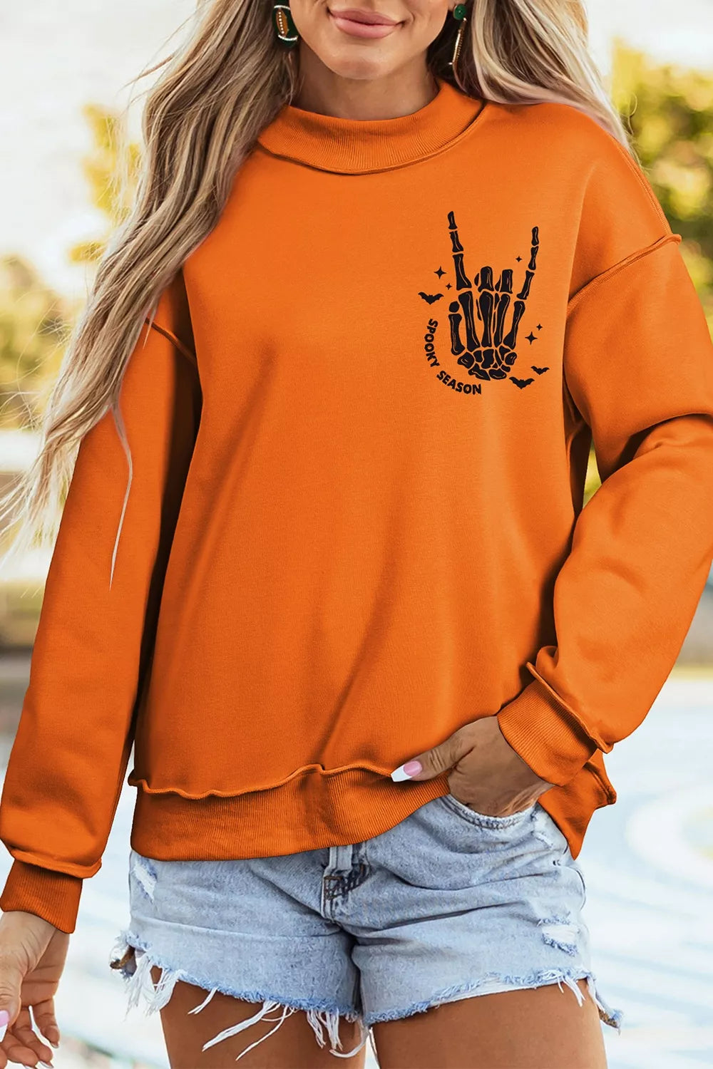Orange mock neck sweatshirt with &