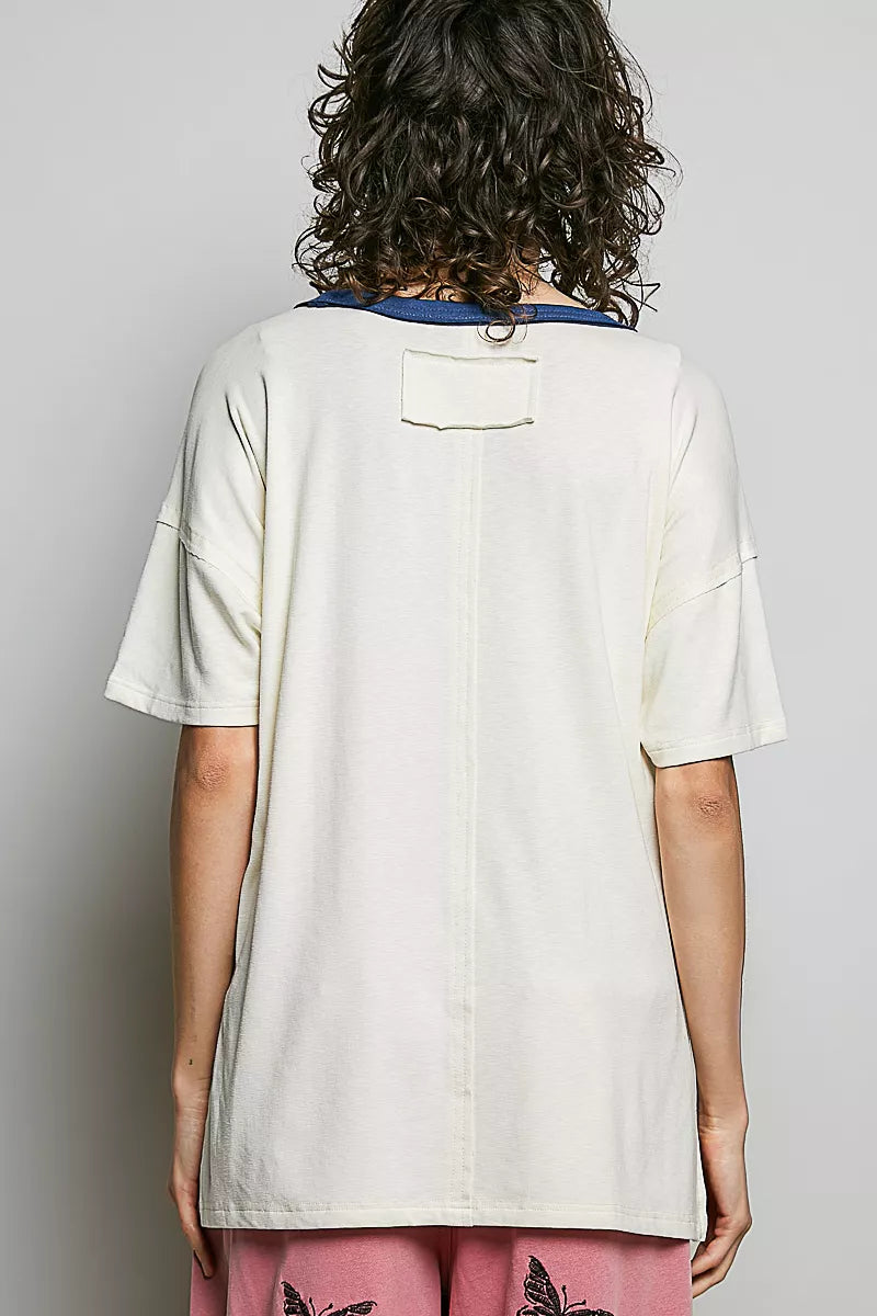 Cream cotton top back view with short sleeves and small buttoned placket