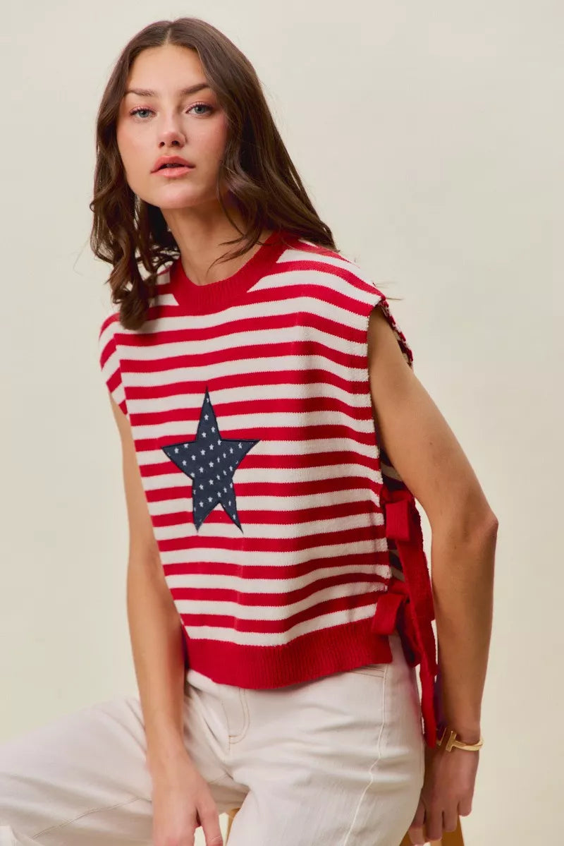 Red and ivory striped sleeveless vest top with navy star patch and tied side accents
