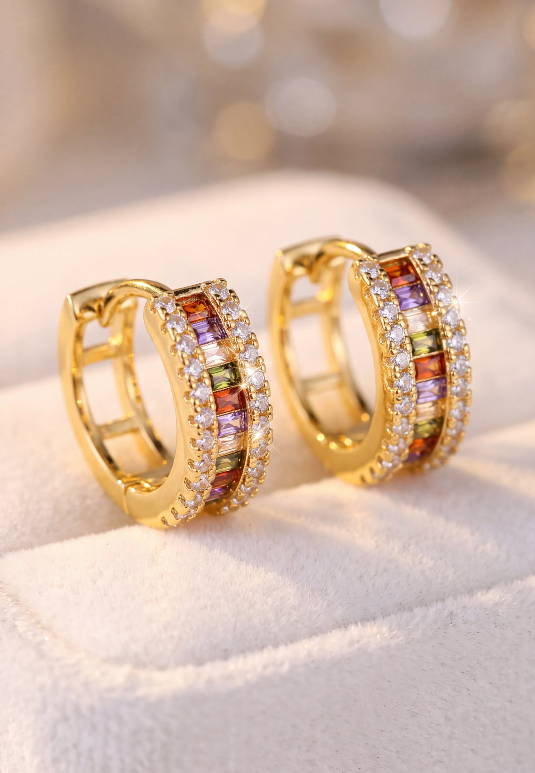 Gold baguette huggie hoop earrings with rainbow stones and clear pavé accents