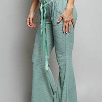 Pale sage ribbed knit pants with drawstring ties and wide flared legs