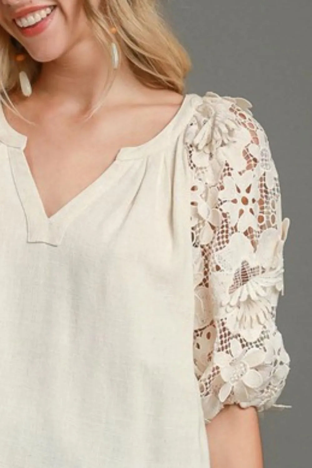 Oatmeal top with V-neck and 3/4 puff sleeve covered in 3D floral lace detail