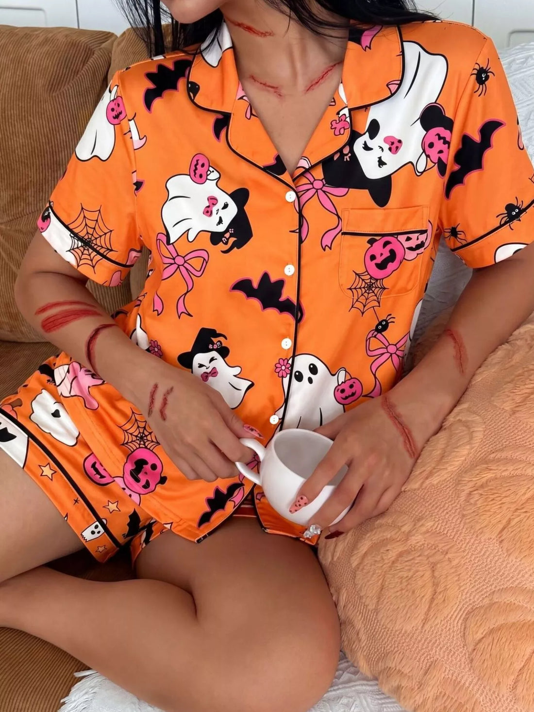 Orange Halloween pajama set: button-front short-sleeve top with ghost and pumpkin prints