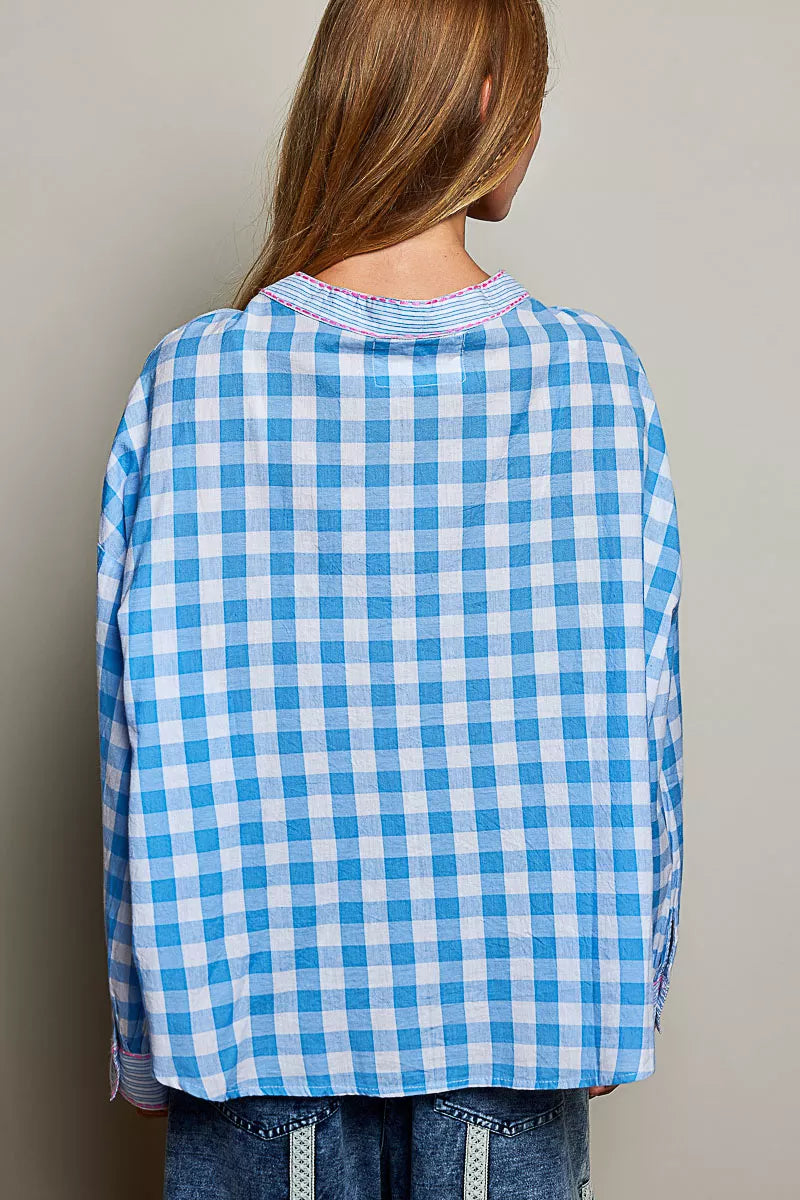 Back view of blue gingham embroidered blouse with ruffled collar and long sleeves