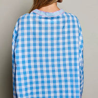 Back view of blue gingham embroidered blouse with ruffled collar and long sleeves
