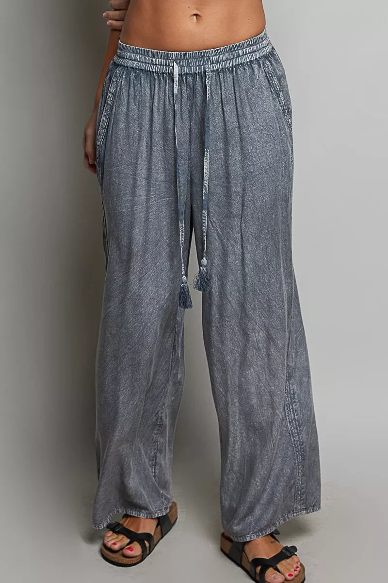 Charcoal wide-leg woven pants with elastic waist and dangling tassel drawstring