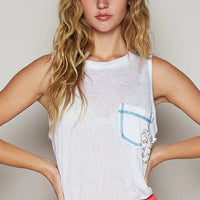 White tank top with blue-trimmed chest pocket and floral print detailing