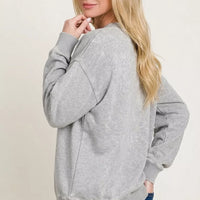 Women's gray crewneck fleece sweatshirt, side view with ribbed cuffs and hem