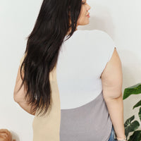 Back view of color-block knit top with V-neck back; beige and gray paneling